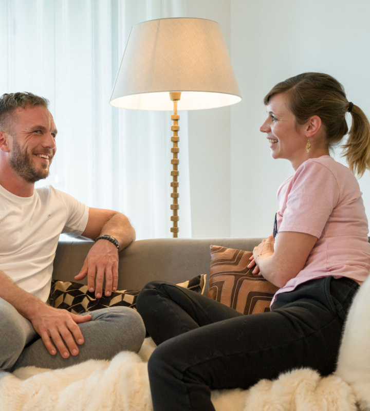 Un couple assis confortablement sur un canapé profitant d'un chauffage performant
