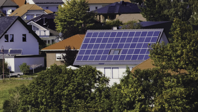 Luftaufnahme von Häusern mit Solarmodulen auf den Dächern, die das Engagement von Groupe E für nachhaltige Solarlösungen für Privatkunden hervorheben